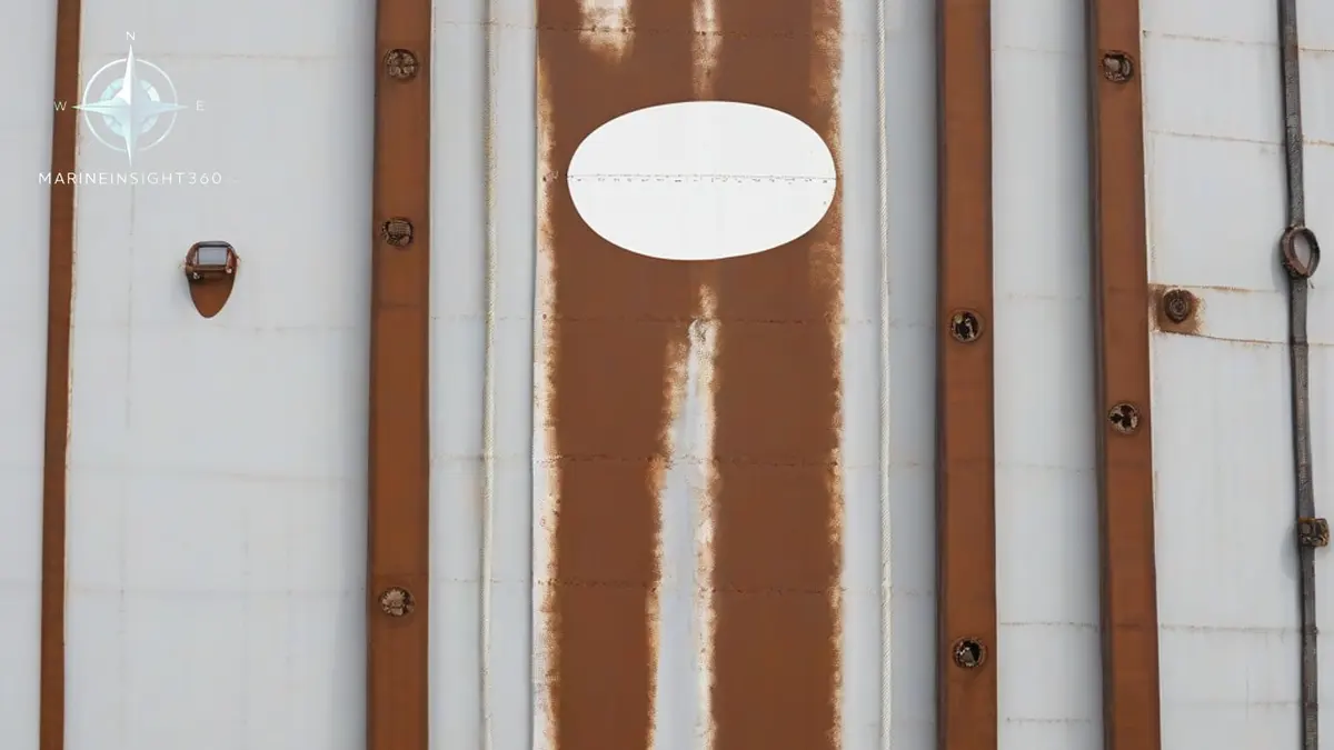 Plimsoll load line mark and season lines painted on a cargo ship's hull at the waterline